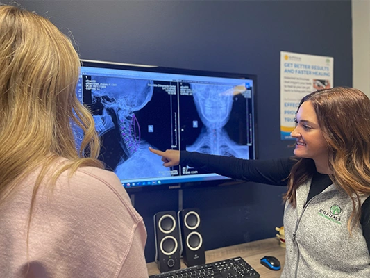 Chiropractor Columbia MO Chelsey Aitken Pointing To XRay