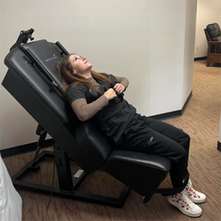 Chiropractic Columbia MO Woman Using Spinal Decompression Machine